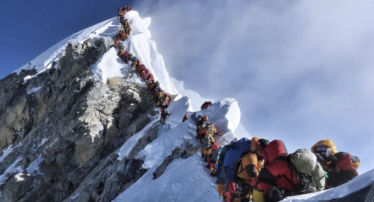 In this photo made on May 22, 2019, a long queue of mountain climbers line a path on Mount Everest. About half a dozen climbers died on Everest last week most while descending from the congested summit during only a few windows of good weather each May. (Nirmal Purja/@Nimsdai Project Possible via AP)